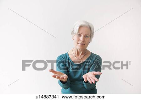 Stock Image - Older woman reaching forward. Fotosearch