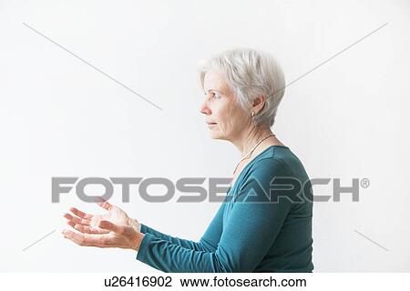 Stock Image - Older woman reaching forward. Fotosearch