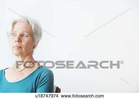 Older woman sitting in chair View Large Photo Image Picture - Older woman sitting in chair. Fotosearch
