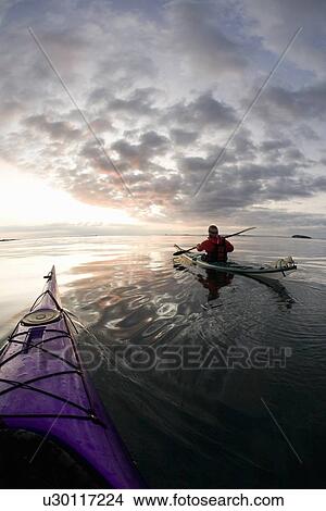 People kayaking on still lake View Large Photo Image Picture - People kayaking on still lake. Fotosearch