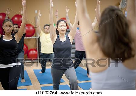 People practicing yoga in studio View Large Photo Image Picture - People practicing yoga in studio. Fotosearch