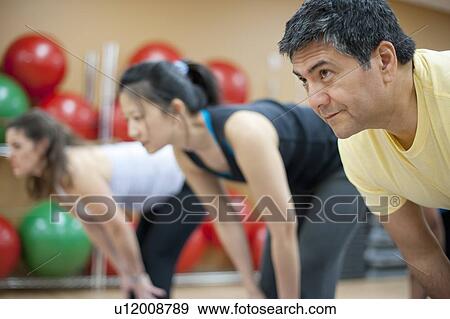 People practicing yoga in studio View Large Photo Image Stock Photo - People practicing yoga in studio. Fotosearch