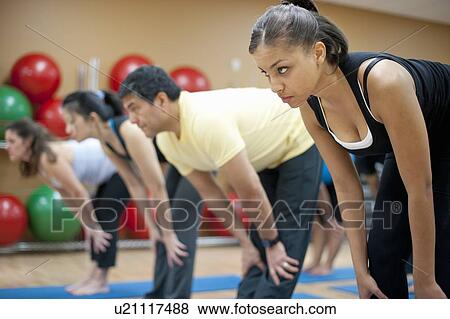 People practicing yoga in studio View Large Photo Image Stock Photo - People practicing yoga in studio. Fotosearch