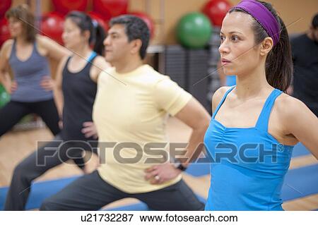 People practicing yoga in studio View Large Photo Image Stock Photo - People practicing yoga in studio. Fotosearch