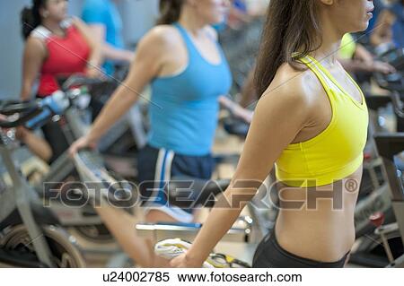 People stretching on spin machines View Large Photo Image Stock Photography - People stretching on spin machines. Fotosearch