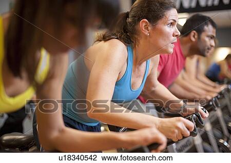People using spin machines in gym View Large Photo Image Stock Image - People using spin machines in gym. Fotosearch