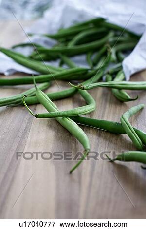 Stock Photo - Pile of green beans on board. Fotosearch