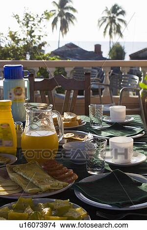 Picture - Plates and glasses of food at table. Fotosearch