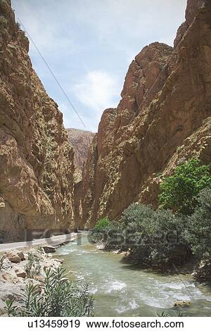 Stock Photo - River running through mountain valley. Fotosearch