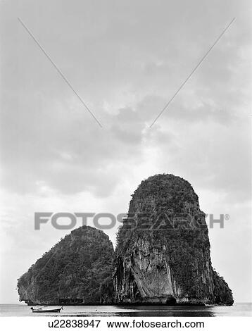 Rocky island in still lake View Large Photo Image Stock Photo - Rocky island in still lake. Fotosearch
