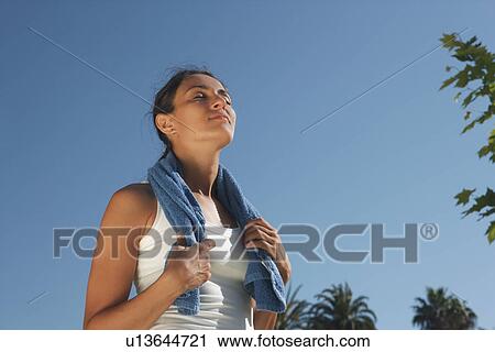 Stock Image - Runner wearing towel around neck. Fotosearch