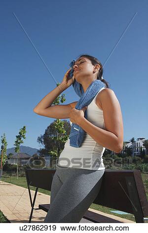 Stock Photo - Runner wiping sweat from face. Fotosearch