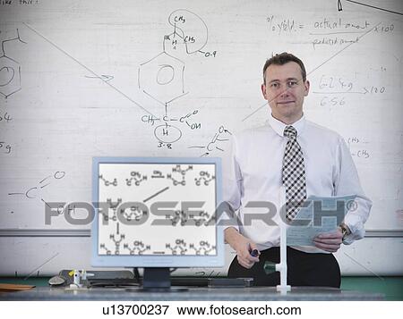 Stock Photo - Science teacher at desk with computer. Fotosearch
