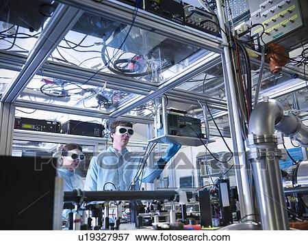 Scientist adjusting oscilloscope in lab View Large Photo Image Stock Photo - Scientist adjusting oscilloscope in lab. Fotosearch