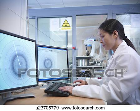 Stock Photo - Scientist using computer in lab. Fotosearch