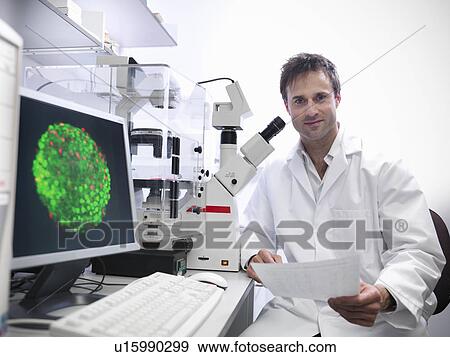 Stock Photo - Scientist using microscope in lab. Fotosearch