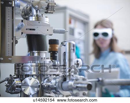 Scientist using vacuum chamber in lab View Large Photo Image Picture - Scientist using vacuum chamber in lab. Fotosearch