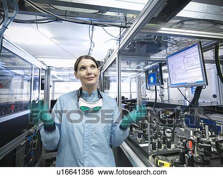 Stock Photograph - Scientist walking in lab. Fotosearch