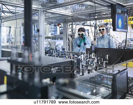 Stock Photo - Scientists working together in lab. Fotosearch