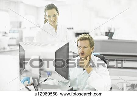 Stock Photo - Scientists working together in lab. Fotosearch