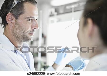 Stock Photo - Scientists working together in lab. Fotosearch