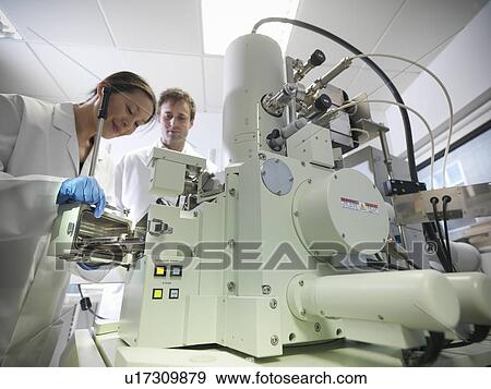 Scientists working with equipment in lab View Large Photo Image Stock Photo - Scientists working with equipment in lab. Fotosearch