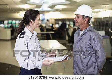 Security personnel talking to worker View Large Photo Image Picture - Security personnel talking to worker. Fotosearch