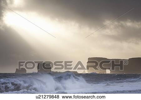 Silhouette of cliffs on stormy beach View Large Photo Image Stock Photo - Silhouette of cliffs on stormy beach. Fotosearch