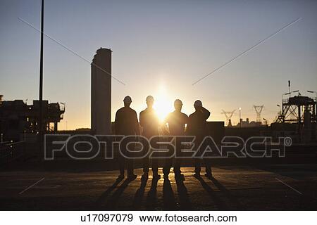 Silhouette of workers at oil refinery View Large Photo Image Stock Photo - Silhouette of workers at oil refinery. Fotosearch