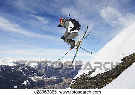 Skier jumping off snowy slope View Large Photo Image Stock Photography - Skier jumping off snowy slope. Fotosearch