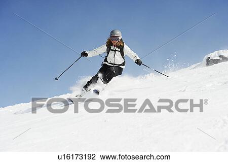 Skier skiing on snowy slope View Large Photo Image Stock Image - Skier skiing on snowy slope. Fotosearch