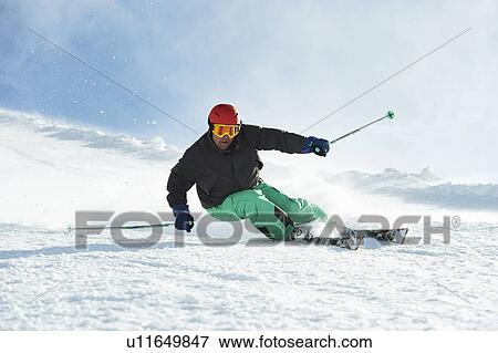 Skier skiing on snowy slope View Large Photo Image Stock Photo - Skier skiing on snowy slope. Fotosearch