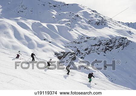 Skiers skiing together on slope View Large Photo Image Picture - Skiers skiing together on slope. Fotosearch