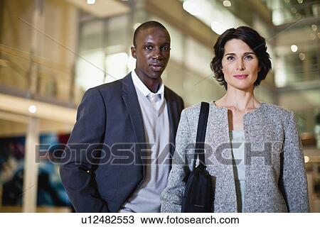 Smiling business people in lobby View Large Photo Image Stock Image - Smiling business people in lobby. Fotosearch