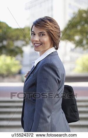 Smiling businesswoman standing outdoors View Large Photo Image Stock Image - Smiling businesswoman standing outdoors. Fotosearch