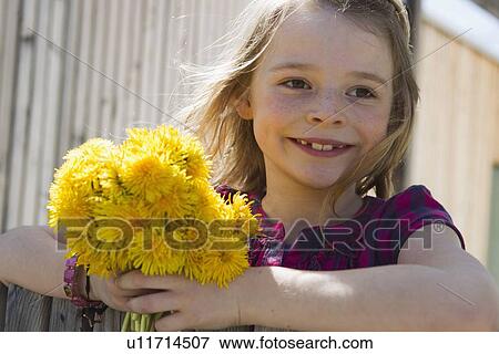 Stock Photo - Smiling girl carrying bouquet of flowers. Fotosearch