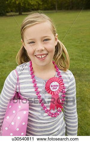 Smiling girl holding birthday present View Large Photo Image Stock Image - Smiling girl holding birthday present. Fotosearch