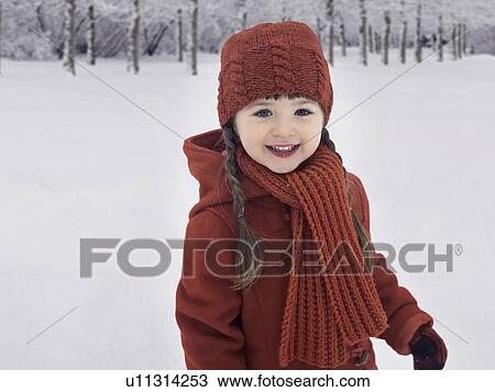 Smiling girl playing in snow View Large Photo Image Stock Image - Smiling girl playing in snow. Fotosearch