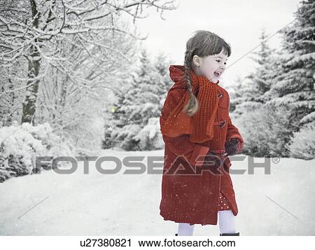 Stock Image - Smiling girl playing in snow. Fotosearch