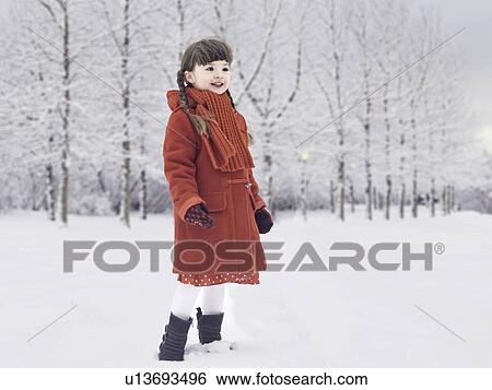 Smiling girl playing in snow View Large Photo Image Stock Photograph - Smiling girl playing in snow. Fotosearch