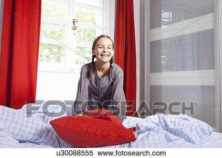 Smiling girl playing on bed View Large Photo Image Stock Photography - Smiling girl playing on bed. Fotosearch