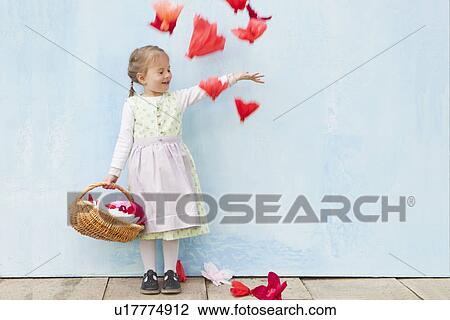 Smiling girl playing with paper flowers View Large Photo Image Stock Image - Smiling girl playing with paper flowers. Fotosearch