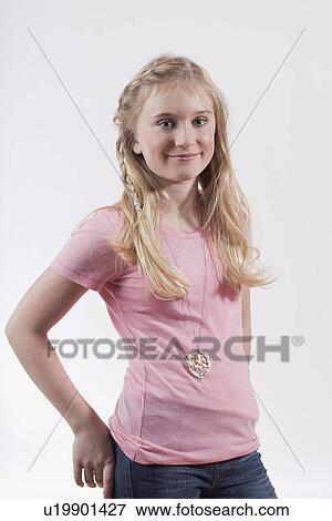 Stock Photo - Smiling girl with hands in pockets. Fotosearch