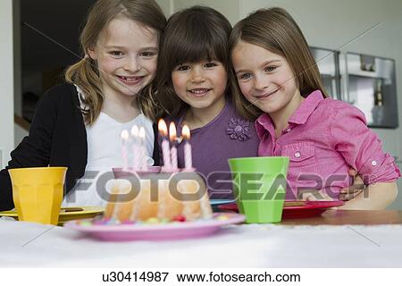 Smiling girls hugging at birthday party View Large Photo Image Stock Photo - Smiling girls hugging at birthday party. Fotosearch