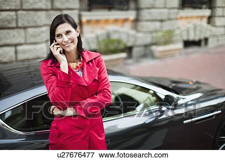 Stock Photo - Smiling woman talking on cell phone. Fotosearch