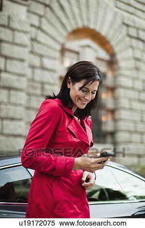 Stock Photography - Smiling woman talking on cell phone. Fotosearch