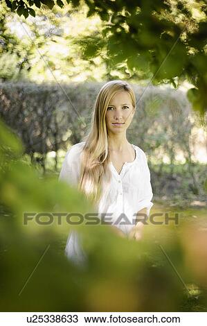 Stock Image - Smiling woman walking outdoors. Fotosearch