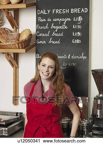 Smiling woman working in bakery View Large Photo Image Stock Image - Smiling woman working in bakery. Fotosearch