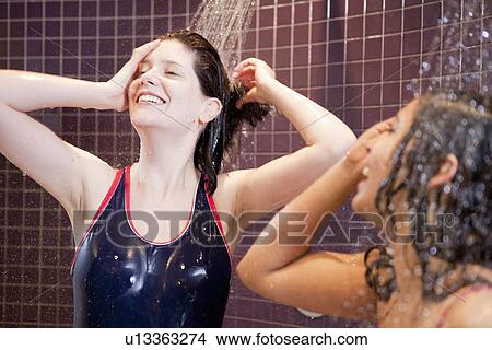 Smiling women showering in pool View Large Photo Image Picture - Smiling women showering in pool. Fotosearch