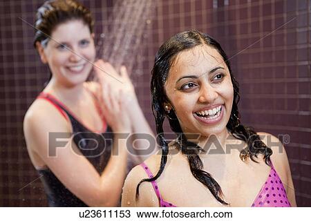 Smiling women showering in pool View Large Photo Image Stock Image - Smiling women showering in pool. Fotosearch